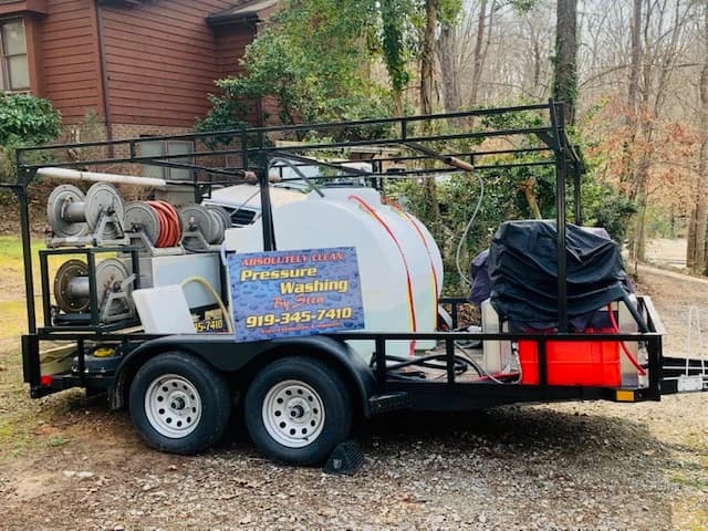 Professional exterior cleaning trailer with hoses and equipment